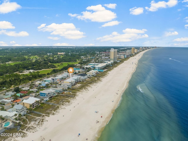 birds eye view of property with a water view and a beach view