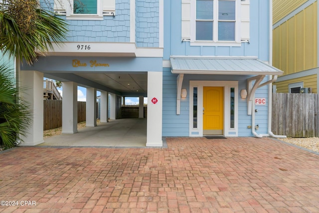 property entrance with a carport