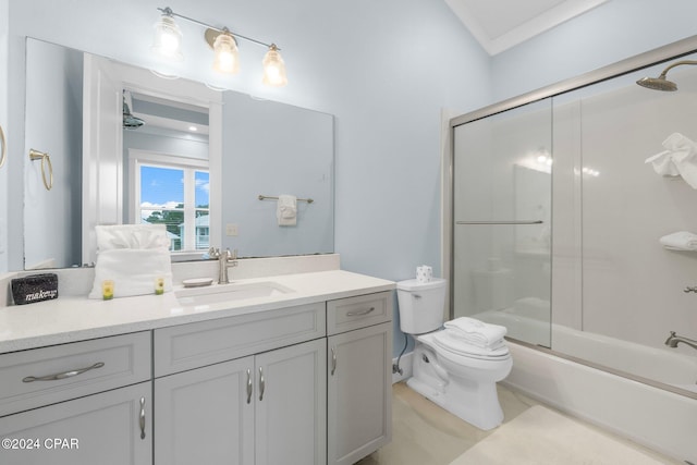 full bathroom featuring vanity, crown molding, bath / shower combo with glass door, and toilet