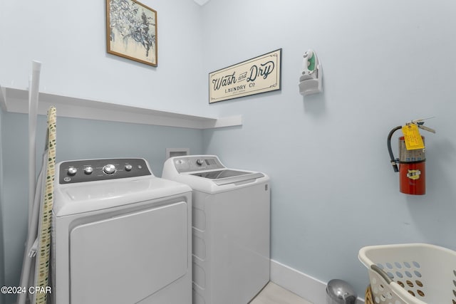 clothes washing area with separate washer and dryer