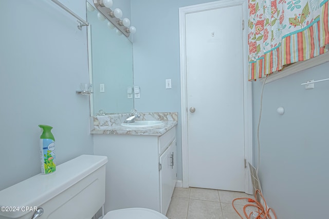 bathroom featuring vanity, toilet, and tile patterned floors