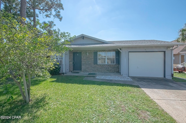 single story home with a front yard and a garage