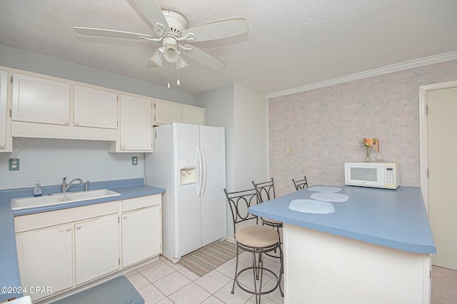 kitchen with white appliances, sink, a textured ceiling, ceiling fan, and crown molding