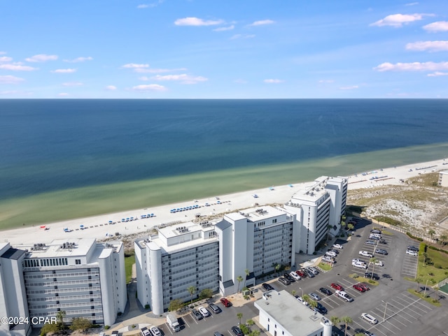 drone / aerial view featuring a water view and a view of the beach