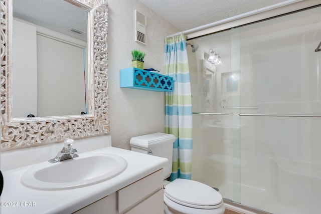 bathroom with vanity, toilet, a textured ceiling, and walk in shower