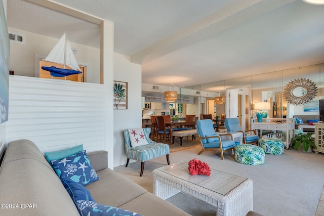 carpeted living room featuring a textured ceiling