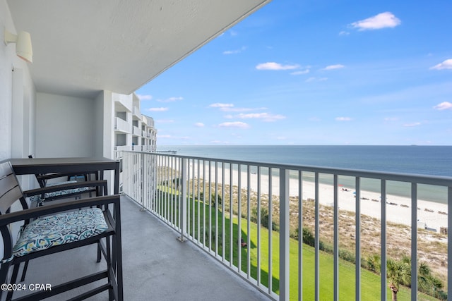 balcony with a beach view and a water view