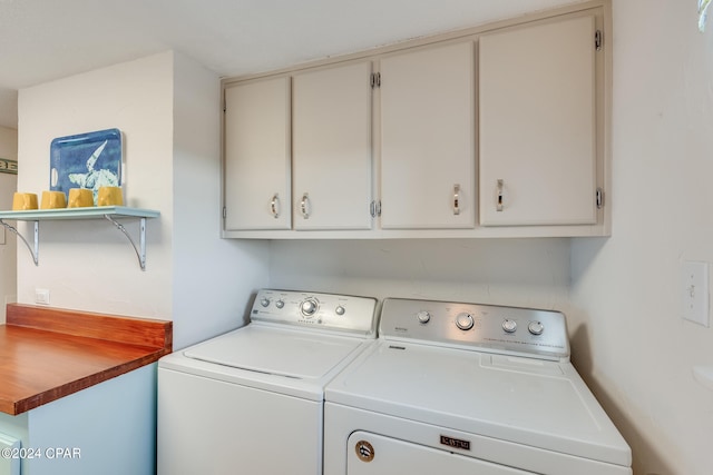 laundry area with cabinets and washing machine and dryer