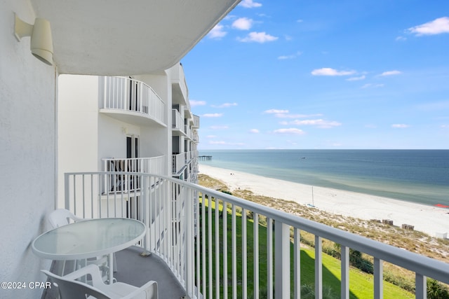 balcony featuring a water view and a beach view