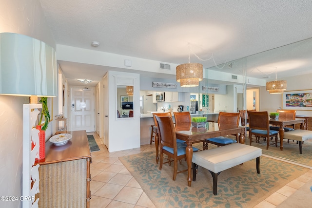 4425 Thomas Dr Unit 707, Panama City, FL 32408 - dining area featuring light tile patterned floors and a textured ceiling