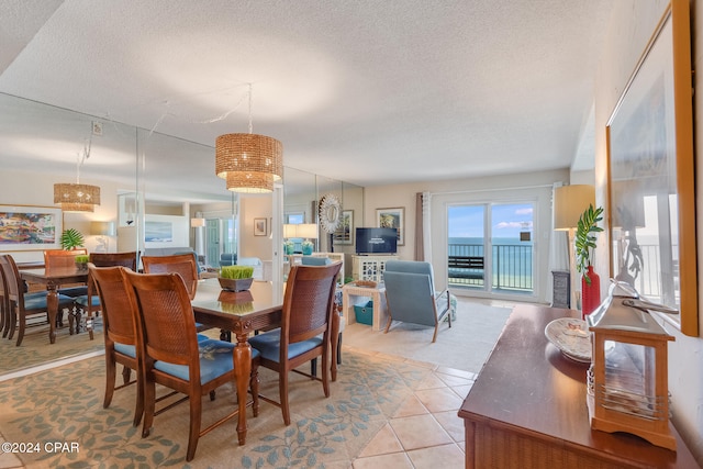 tiled dining area featuring a textured ceiling