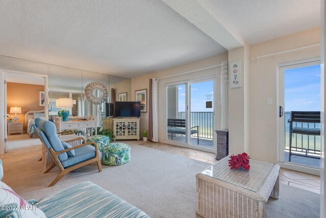 4425 Thomas Dr Unit 707, Panama City, FL 32408 - living area with carpet flooring, a textured ceiling, and tile patterned floors