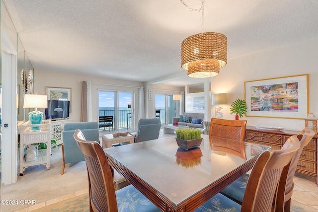 carpeted dining area featuring a textured ceiling