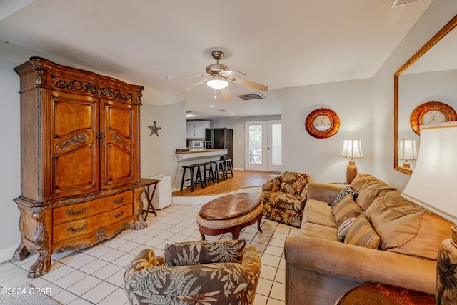 living room featuring light tile patterned floors and ceiling fan