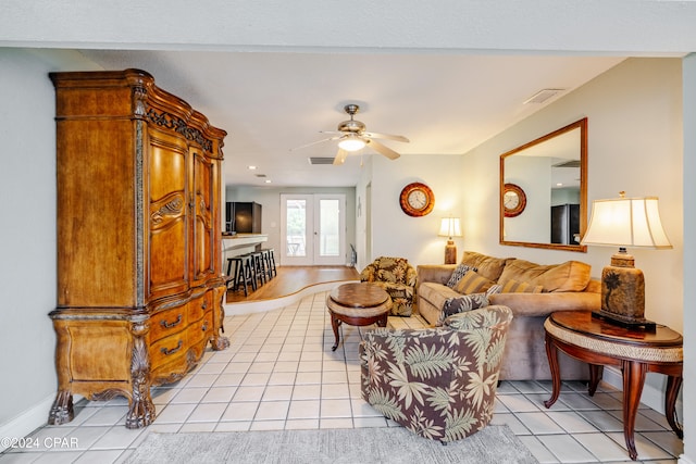 tiled living room with ceiling fan