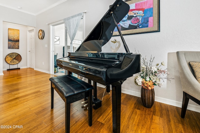 miscellaneous room with ornamental molding and hardwood / wood-style flooring