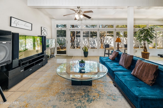 living room with tile patterned flooring, beamed ceiling, and ceiling fan