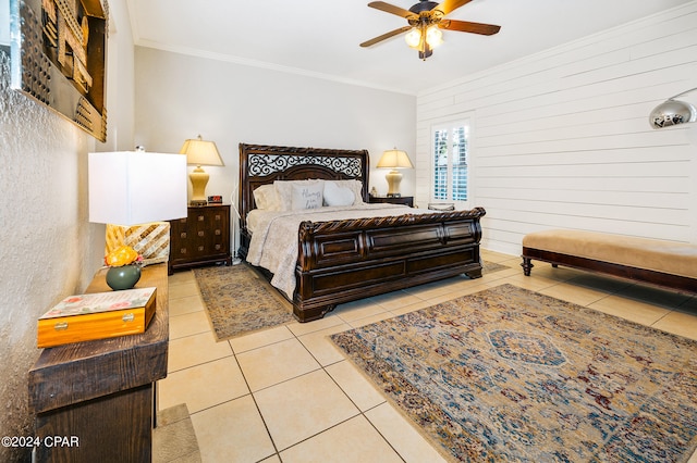 tiled bedroom with wood walls, ceiling fan, and crown molding