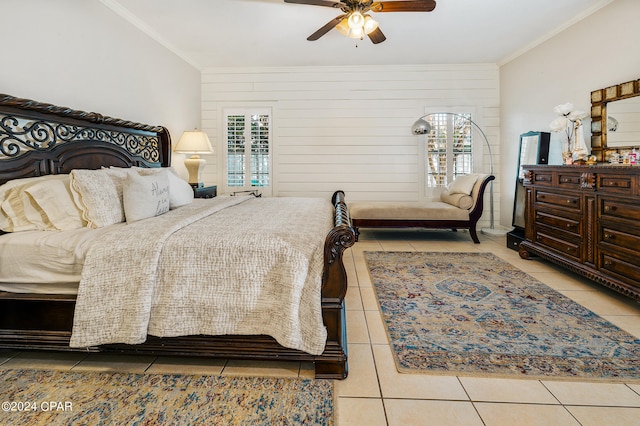 tiled bedroom featuring ceiling fan, wooden walls, and ornamental molding