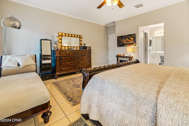 tiled bedroom with ceiling fan, ensuite bath, and ornamental molding