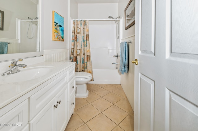 full bathroom featuring toilet, vanity, shower / bath combo with shower curtain, and tile patterned floors