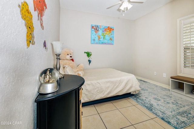 bedroom with ceiling fan and light tile patterned floors