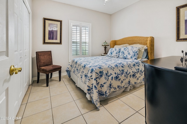 bedroom featuring light tile patterned floors and a closet