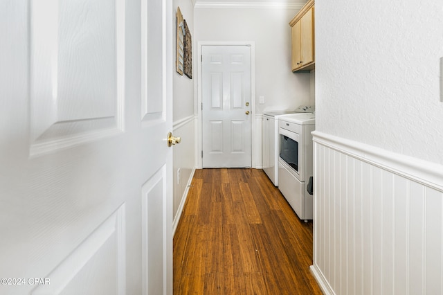 laundry area with cabinets, washer and dryer, dark hardwood / wood-style flooring, and ornamental molding