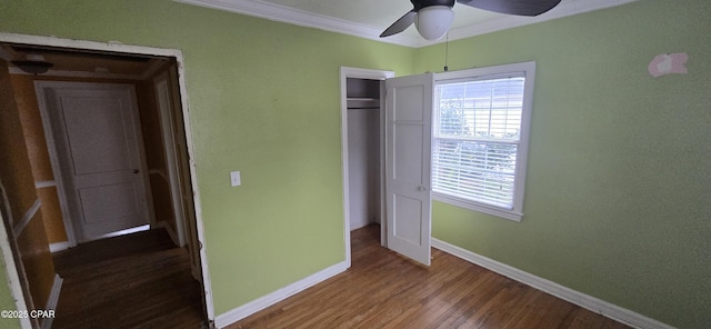 unfurnished bedroom with hardwood / wood-style floors, ceiling fan, crown molding, and a closet