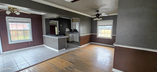 kitchen featuring a healthy amount of sunlight, light wood-type flooring, white cabinetry, and kitchen peninsula