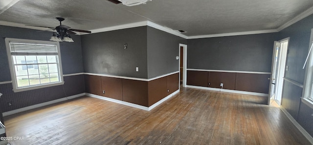 unfurnished room with wood-type flooring, a textured ceiling, ceiling fan, and ornamental molding