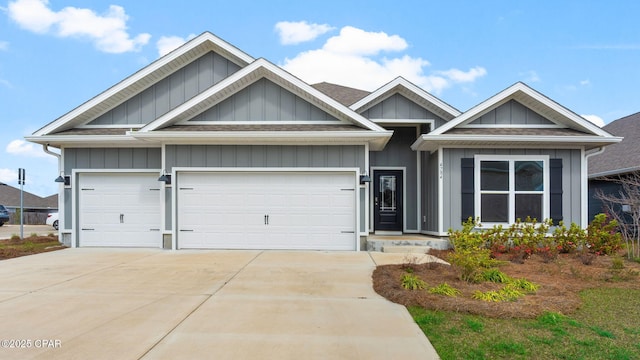 view of front of property with concrete driveway, an attached garage, board and batten siding, and roof with shingles