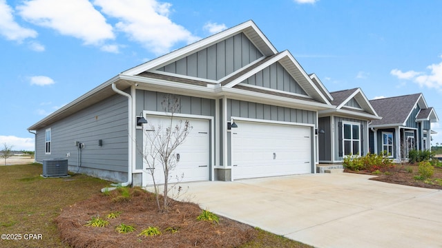 exterior space featuring central air condition unit, board and batten siding, concrete driveway, and an attached garage