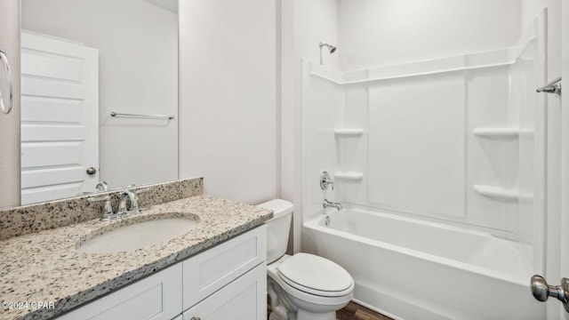 bathroom with vanity,  shower combination, and toilet