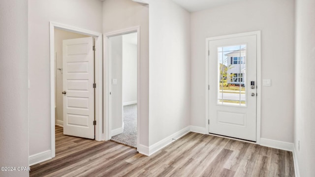 entryway featuring baseboards and light wood finished floors