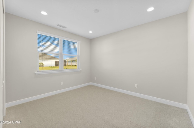 empty room with visible vents, recessed lighting, light colored carpet, and baseboards