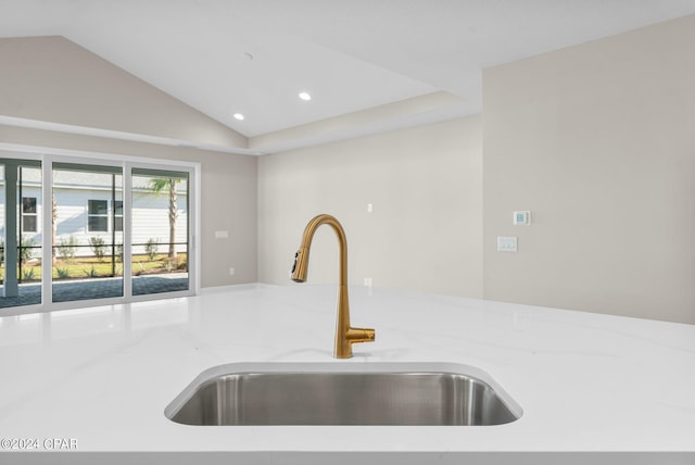 kitchen featuring lofted ceiling and sink