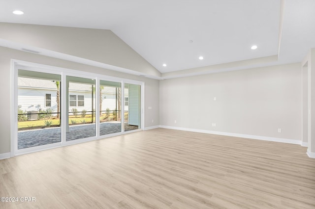 unfurnished living room with baseboards, light wood-style flooring, and lofted ceiling