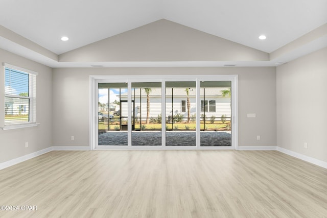 unfurnished room with recessed lighting, baseboards, vaulted ceiling, and light wood finished floors