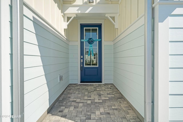 doorway to property featuring board and batten siding