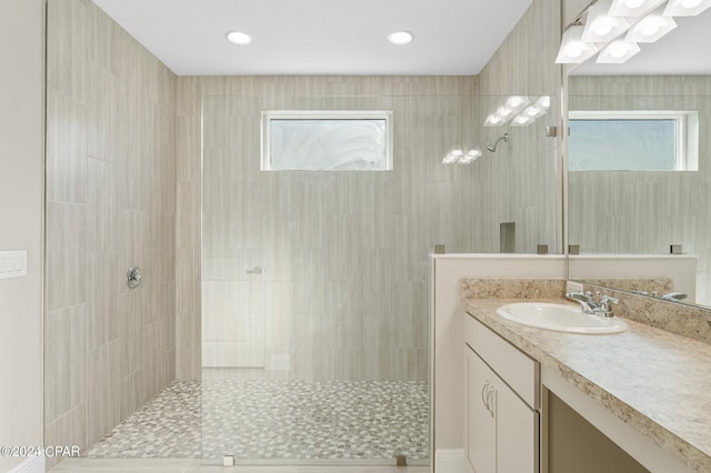 bathroom featuring vanity, plenty of natural light, and walk in shower