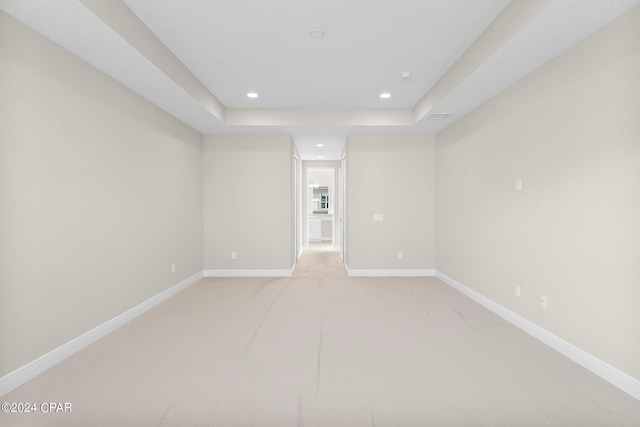 spare room featuring baseboards, light colored carpet, and recessed lighting