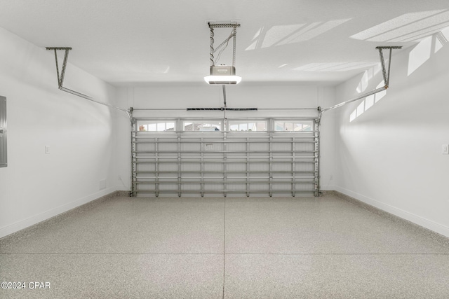garage featuring baseboards and a garage door opener