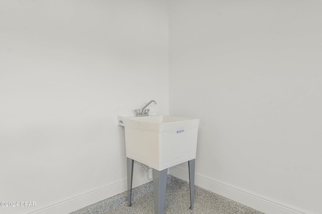 interior space featuring baseboards and speckled floor
