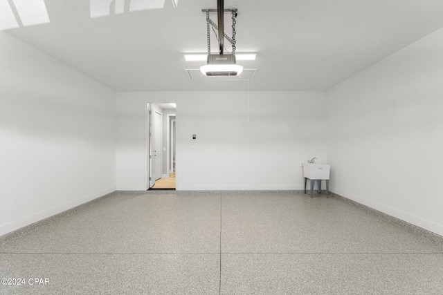 garage with baseboards and a garage door opener