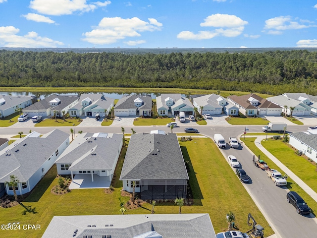 aerial view featuring a residential view, a view of trees, and a water view