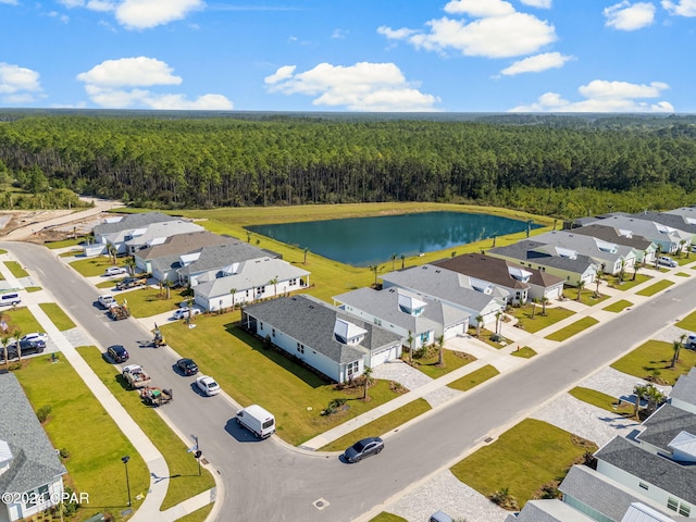 bird's eye view featuring a residential view, a water view, and a forest view