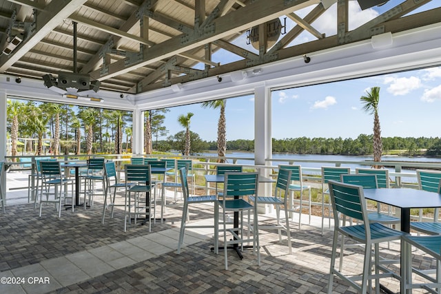 view of patio / terrace featuring a water view and a ceiling fan
