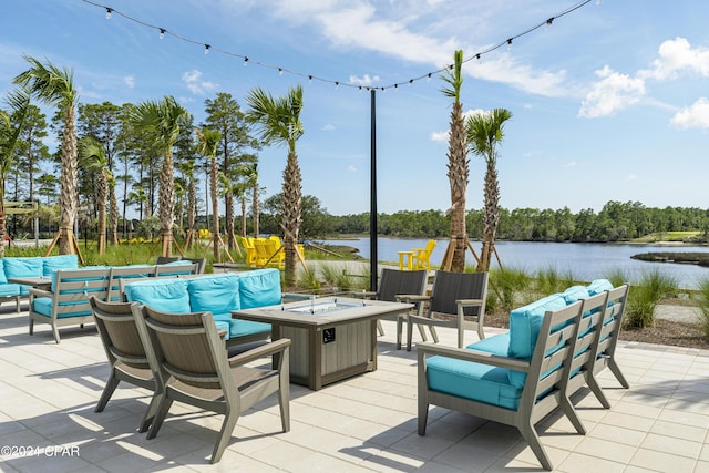 view of patio / terrace featuring a water view and an outdoor living space with a fire pit