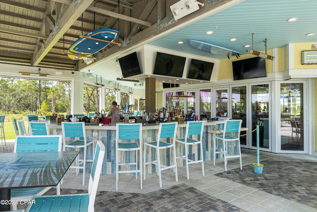 view of swimming pool featuring exterior bar and ceiling fan